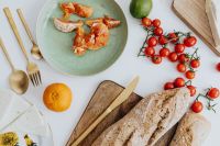 Kaboompics - Overhead Bread, Cheese, Citrus and Cherry Tomatoes Arrangement