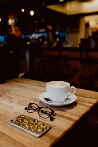 Kaboompics - Cup of coffee on table in cafe, iPhone mobile, glasses