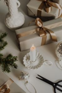 Kaboompics - Beige Christmas Gift Box with Satin Bow and Taper Candle, Neutral Holiday Decor
