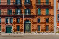 Kaboompics - Ornate Arched Entrance on a Coral Naples Apartment Building