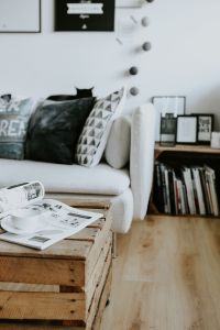 Kaboompics - Black Cat Resting on a Patterned Sofa beneath Monochrome Wall Art, Modern Living Room