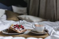 Kaboompics - Wide Bedside Breakfast Still Life with Raspberry Waffles and an Ornate Coffee Cup