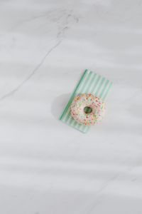 Kaboompics - Donuts on paper napkins placed on white marble