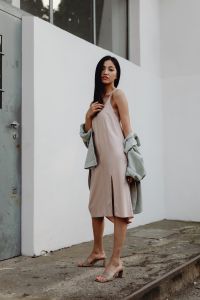Kaboompics - Full Body Woman in Pale Dress and Draped Gray Jacket Outdoors