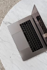 Kaboompics - Single Silver Laptop on Ribbed White Marble, Overhead View