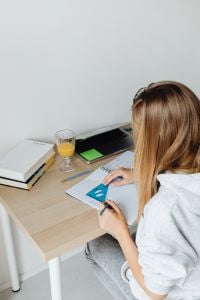 Kaboompics - Teenager Drawing Geometry Homework at Study Desk