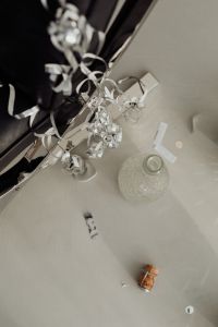 Kaboompics - Disco Ball and Champagne Cork on Wooden Side Table Beside Black Chair