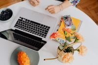 Kaboompics - Top View of Woman Working on a Laptop with Flowers and Blueberries