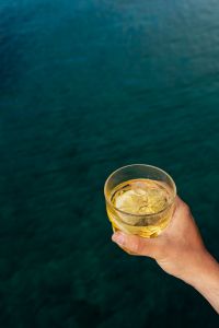 Kaboompics - Yellow Drink above Textured Teal Seawater