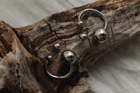 Kaboompics - Statement Silver Sphere Earrings on Weathered Wood