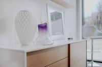 Kaboompics - Room interior with white wooden commode, vase and frames