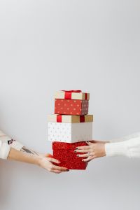 Kaboompics - Minimal Stack of Christmas Presents Held by Hands