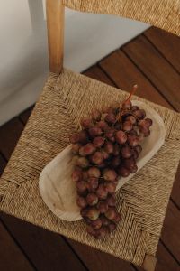 Kaboompics - Overhead Red Grapes on Woven Chair
