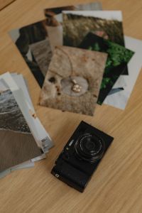 Kaboompics - Printed Photos and Fujifilm Camera on Wooden Desk
