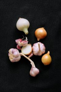 Kaboompics - Onions and Garlic Arranged on a Dark Background