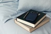 Kaboompics - Smartphone and Books on Soft Blue Bedding