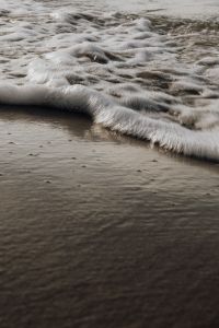Kaboompics - Foamy Wave Receding over Smooth Wet Sand, Minimal Beach Background