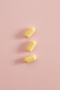 Kaboompics - Three Yellow Tablets on a Pink Background