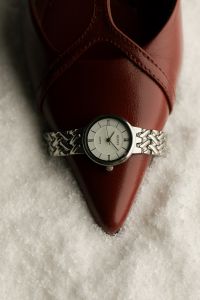 Kaboompics - Wristwatch on Burgundy Leather Shoe in Snow