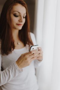 Kaboompics - Beautiful young woman using smartphone