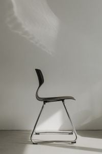Kaboompics - Side View of Dark Sculptural Chair with Wall Shadows