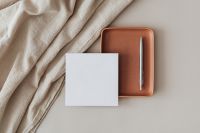 Kaboompics - Blank Card and Silver Pen on Terracotta Leather Tray with Cream Linen
