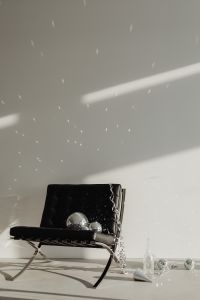 Kaboompics - Black Lounge Chair with Disco Balls and Reflected Light on Wall