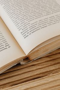 Kaboompics - Angled Printed Pages and Layered Book Edges on Wood for Literary Editorial Design