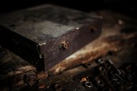 Kaboompics - Weathered Wooden Box With Rusty Hardware on Workshop Bench
