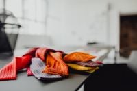 Kaboompics - Close-Up of Folded Red, Rust and Gray Textiles on a Dark Designer Table