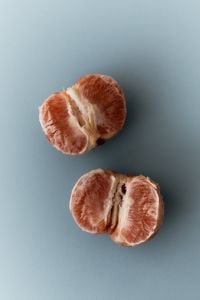 Kaboompics - Grapefruit Half on Blue Background