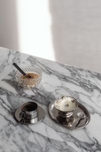 Kaboompics - Chrome Coffee Cup, Silver Bowl of Whipped Cream and Cut-Glass Sugar Bowl on Marble, Metallic Coffee Still Life