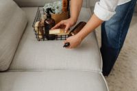 Kaboompics - Hands Organizing a Wire Basket with Cleaning Supplies