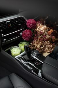 Kaboompics - Autumn Flowers and Iced Matcha on a Car Center Console