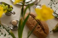Kaboompics - Easter Table Setting with Bread Eggs and Yellow Flowers