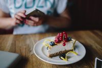 Kaboompics - Berry Cheesecake Slice with Notebook and Blue Pen