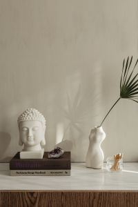 Kaboompics - White Buddha Bust On Books With Amethyst