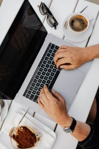 Kaboompics - Hands Working on a Laptop Beside Espresso and Tiramisu