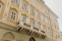 Kaboompics - Ornate Italian Palazzo Balcony and Sunlit Cream Facade