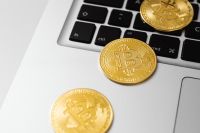 Kaboompics - Bitcoin Coins on Laptop Touchpad