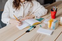Kaboompics - Woman Writing Notes at Desk with Colorful Stationery