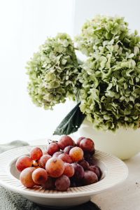 Kaboompics - Hydrangea Bouquet and Grapes in White Ceramic Table Styling