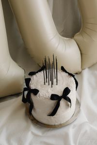 Kaboompics - Close-Up White Cake with Black Bows and Candles