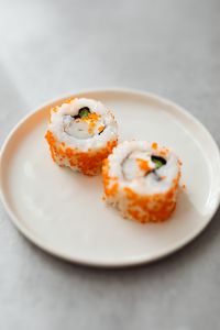 Kaboompics - Tobiko Maki Rolls on a White Plate, Close-Up Japanese Food