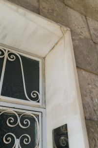 Kaboompics - White Iron Grille and Stone Facade