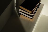 Kaboompics - Minimalist Reading Nook with Stack of Books in Corner