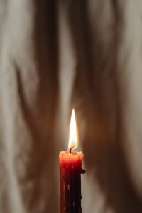 Kaboompics - Red Candle Flame In Soft Focus Against Linen Drapery