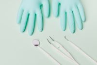 Kaboompics - Dental Mirror and Explorers Beside Nitrile Gloves