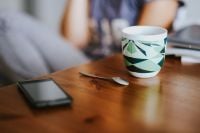 Kaboompics - Black smartphone and a mug