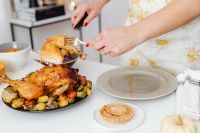 Kaboompics - Serving Turkey Leg from a Festive Roast Platter onto a Plate
